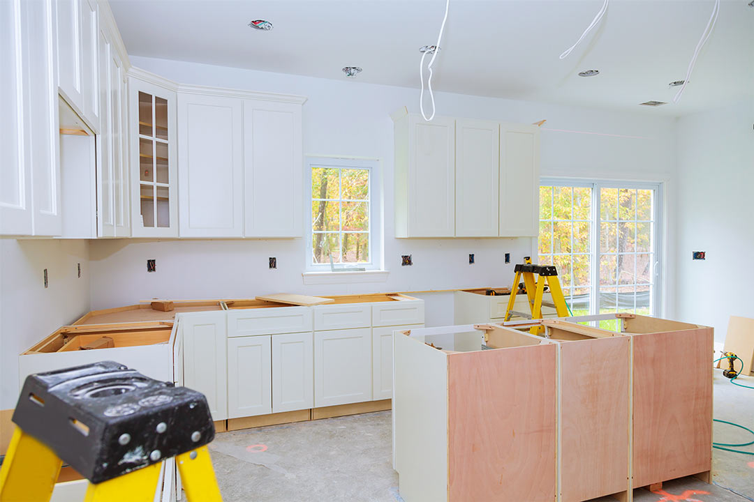 white kitchen cabinets in various stages of installation