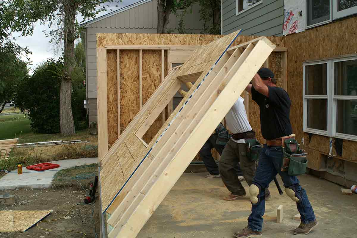 construction workers installing wall frame