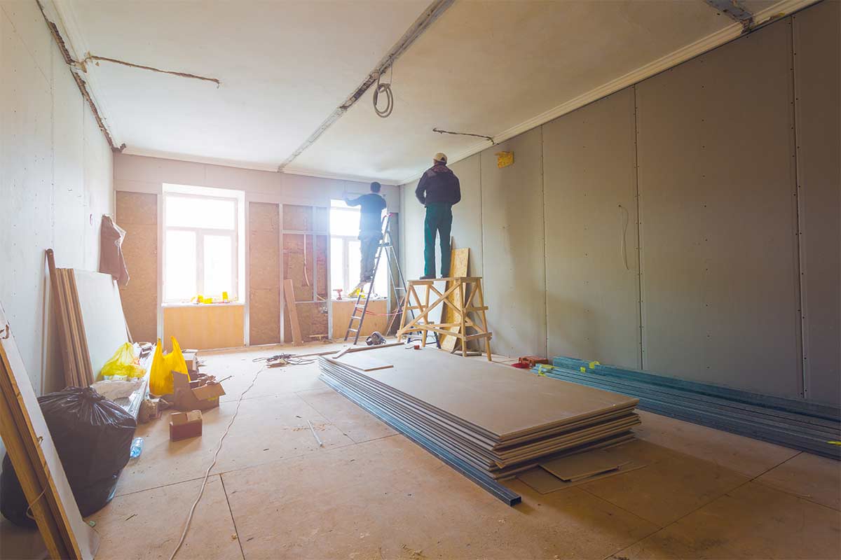 contractors installing drywall in room