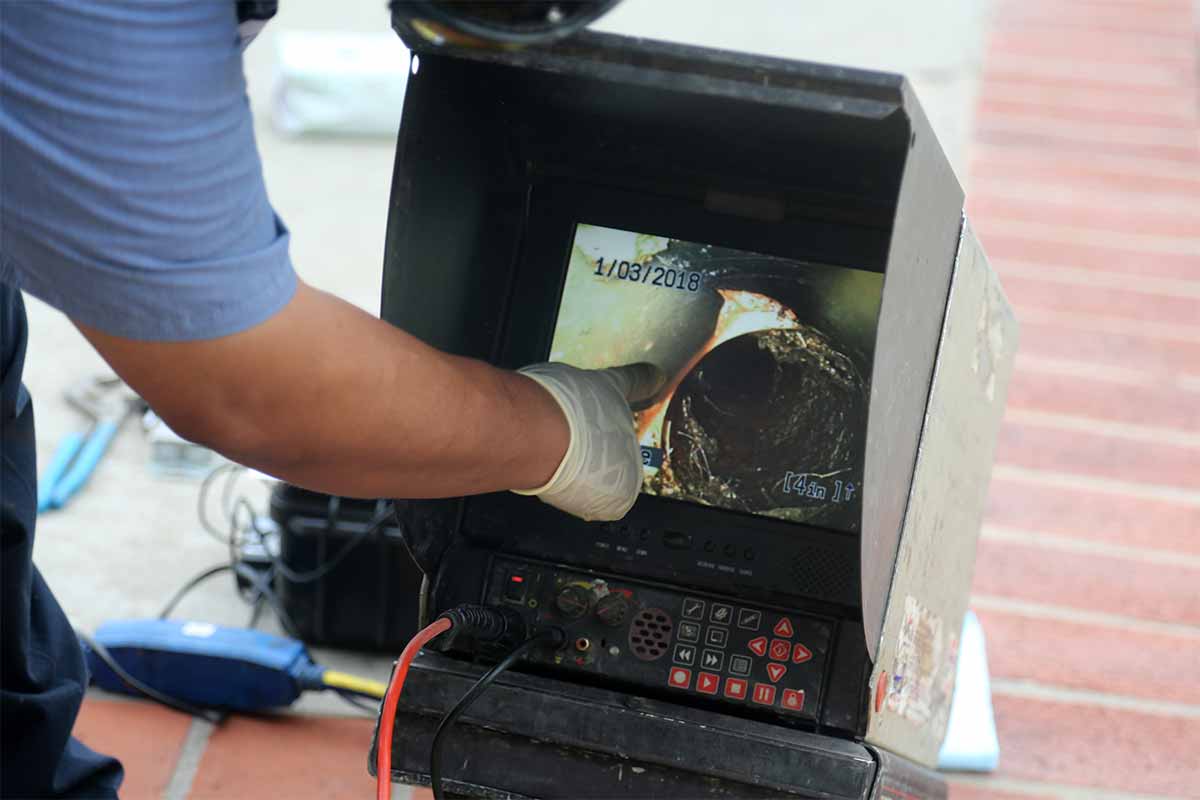 plumber performing camera inspection of residential sewer line