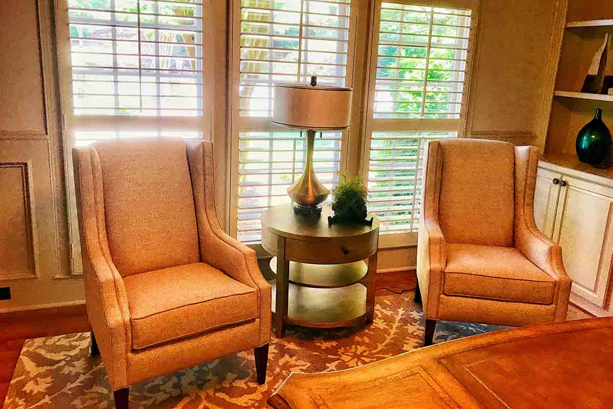 living area with large shuttered windows