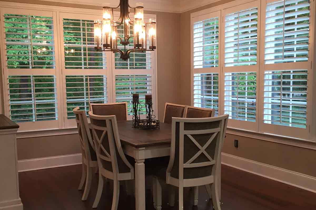 windowed dining area with white plantation shutters