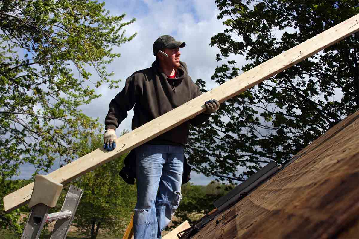 professional roofer repairing roof after storm damage