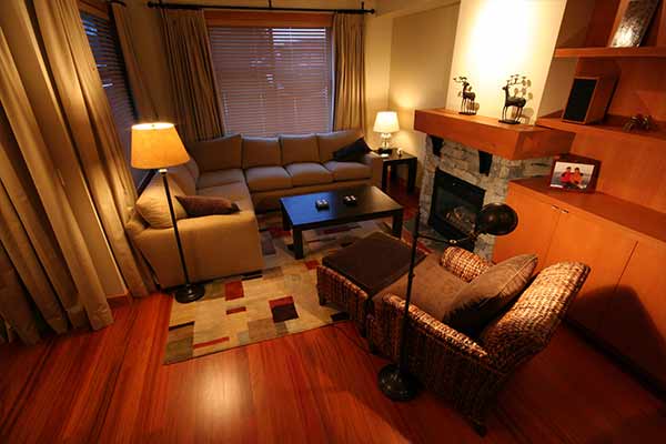 small living room with warm lights and rug