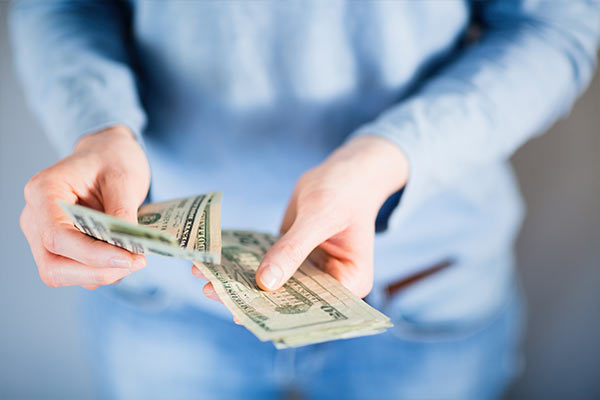 woman's hands counting cash