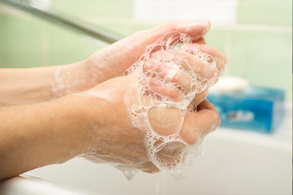 closeup of hands covered in soap