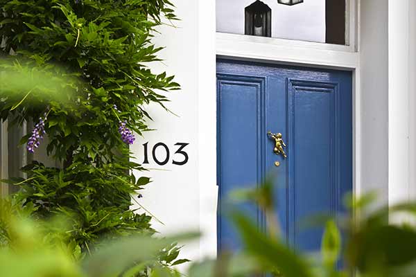 blue front door with vintage accents