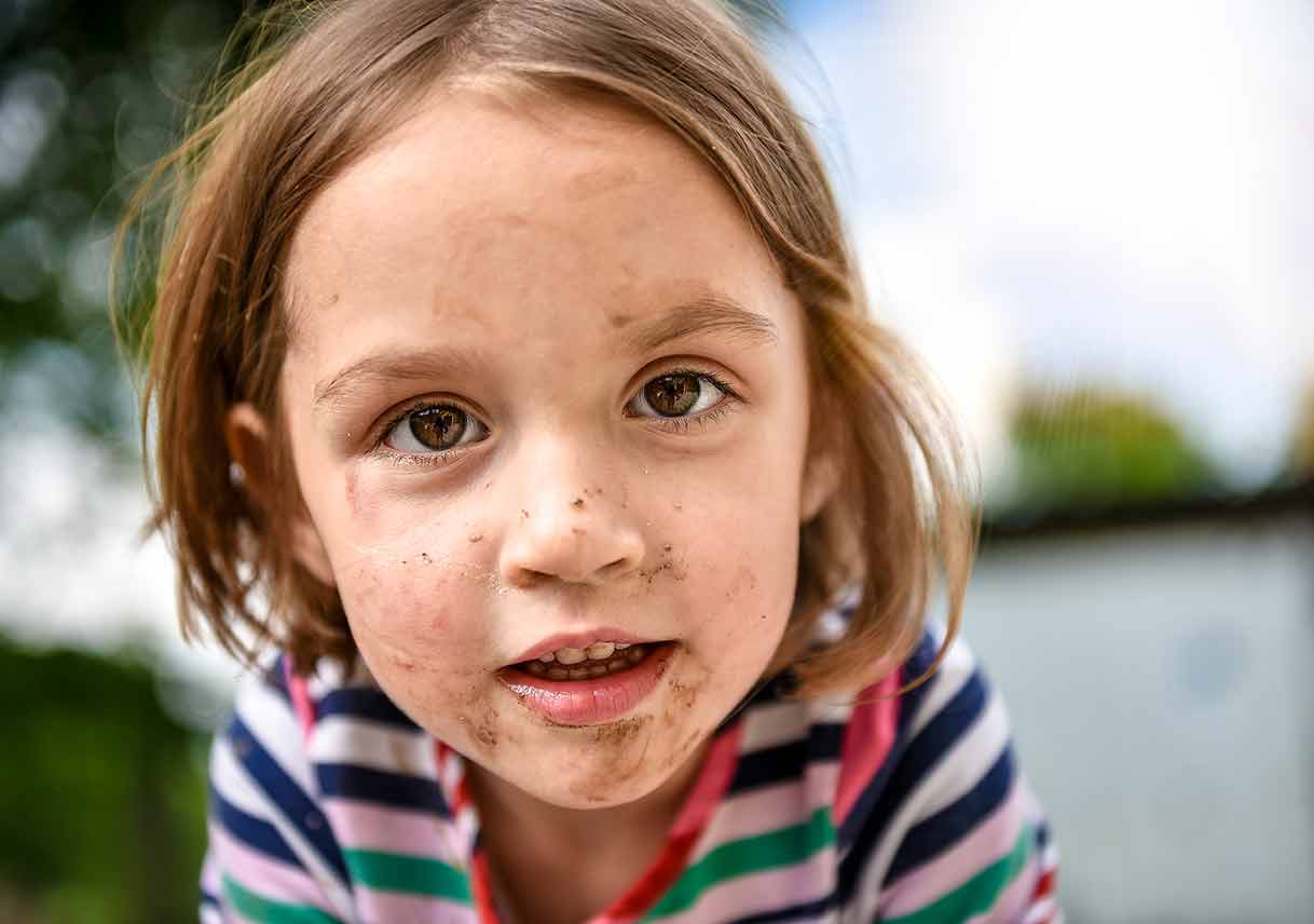 young girl with dirt on face