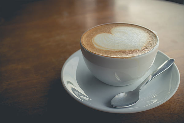 Cup of coffee with heart in foam