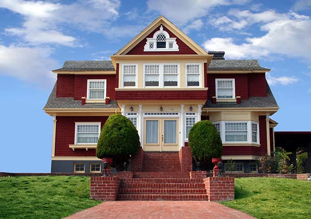 red house with large lawn