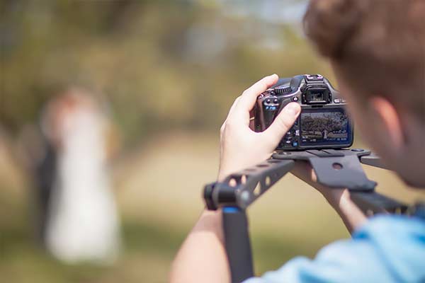 wedding photographer takes photos of bride and groom