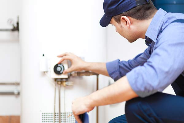 plumber turning down heat on water heater