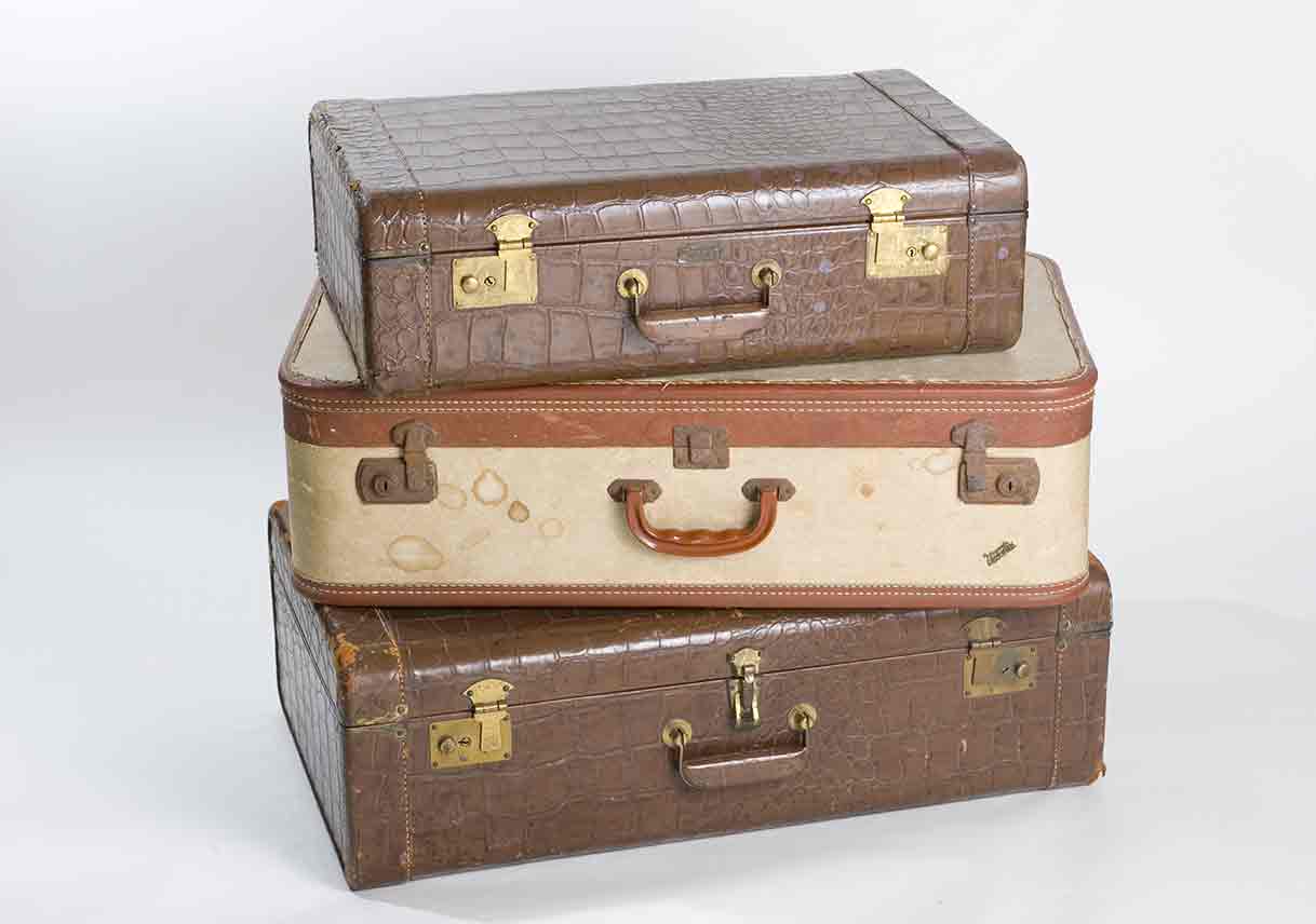 stack of three brown suitcases