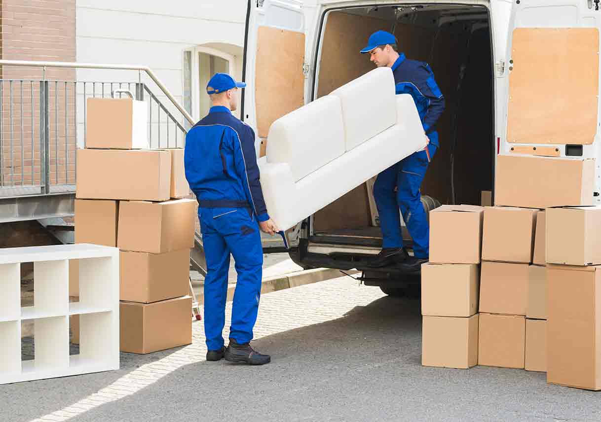 men unloading furniture and boxes from moving truck