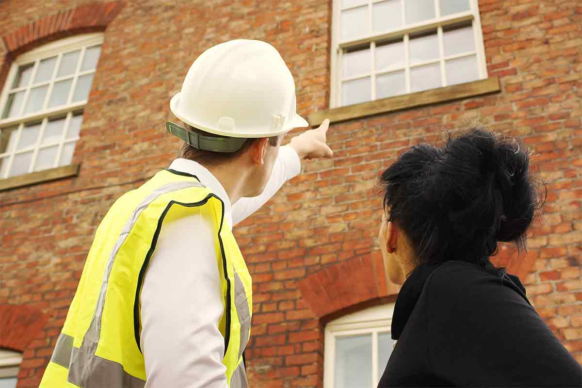 home inspector and buyer looking at home exterior