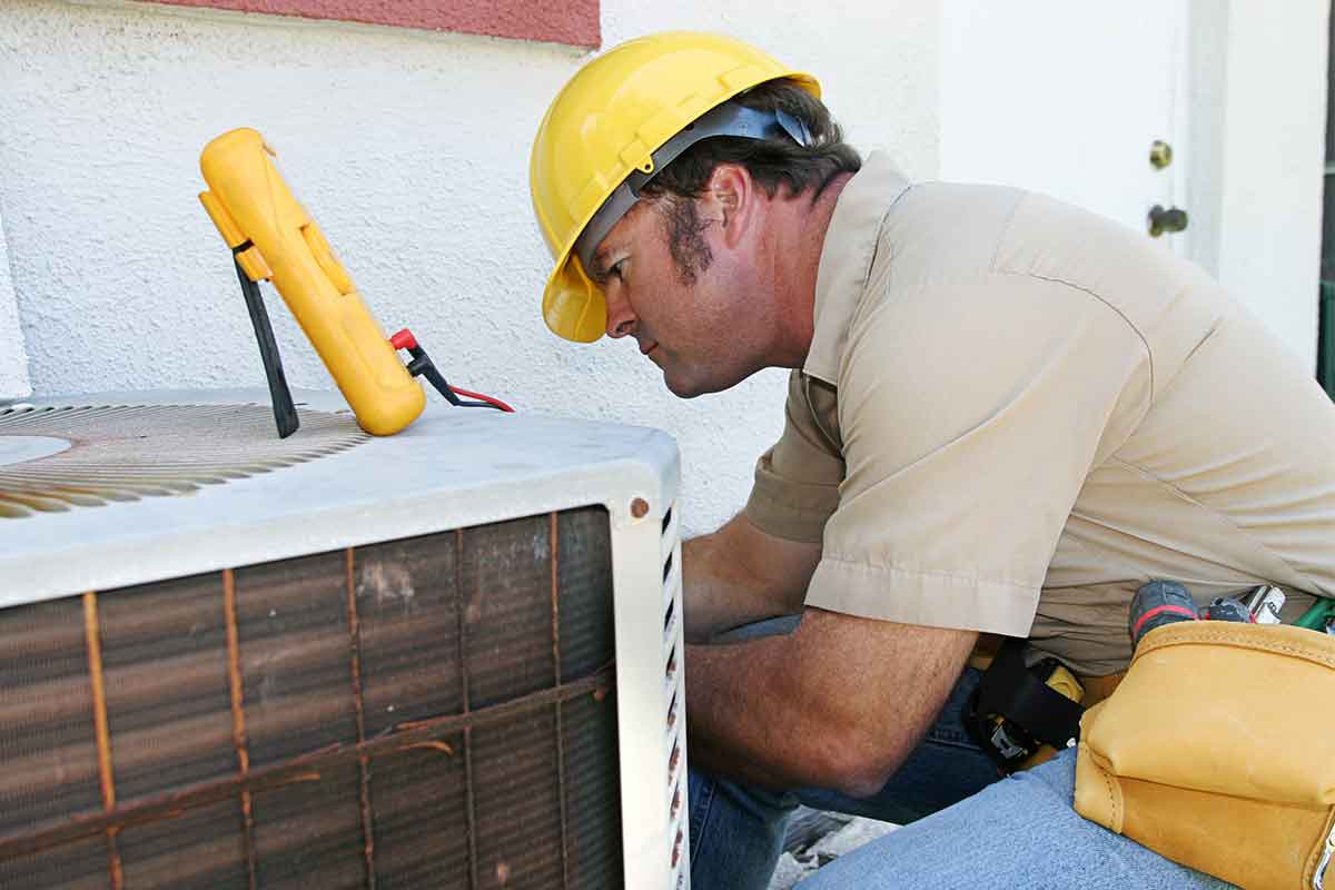 hvac professional fixing an air conditioner