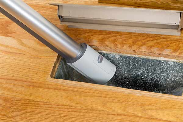 cleaning floor vent with vacuum