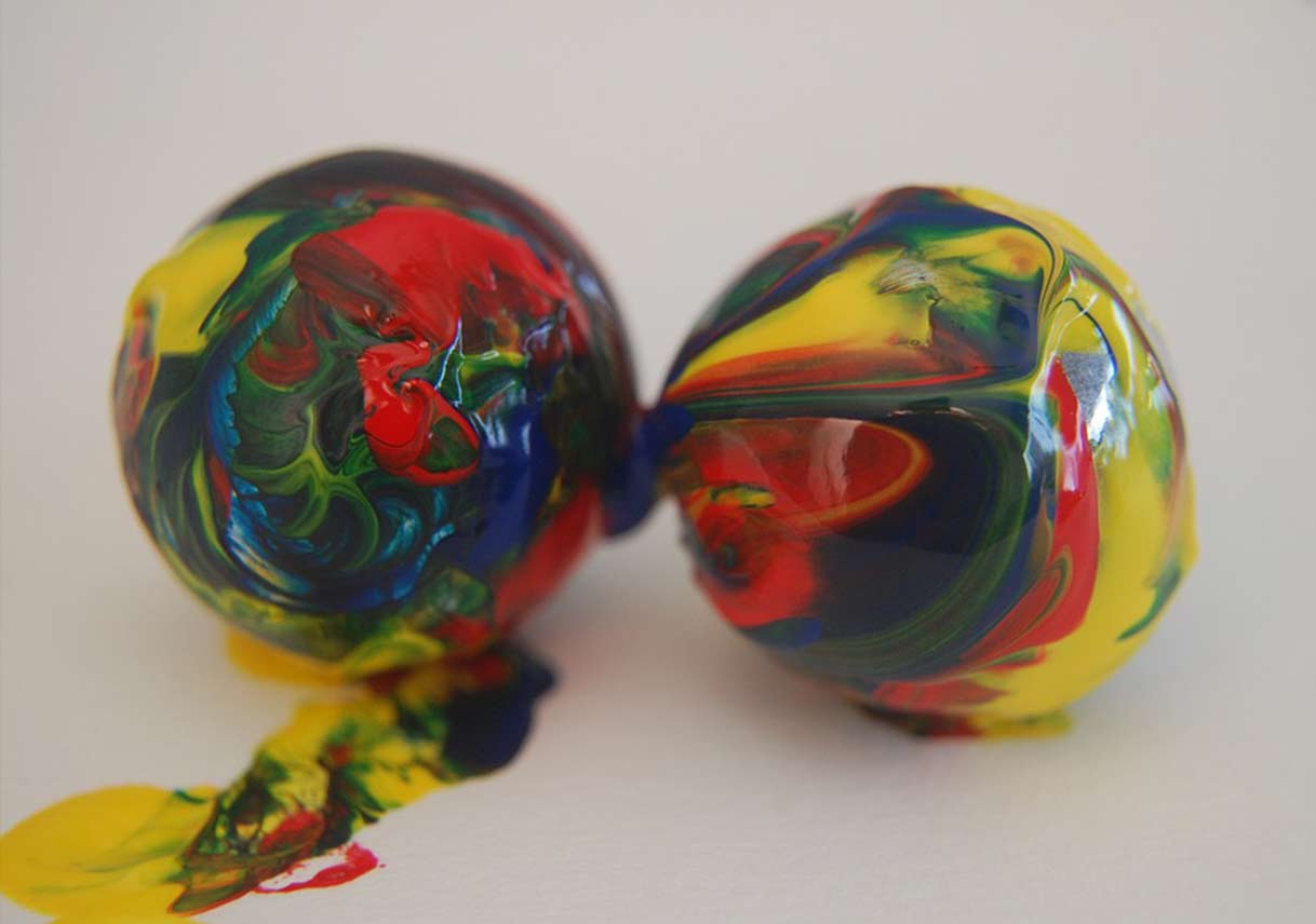 marbles covered in paint on white paper