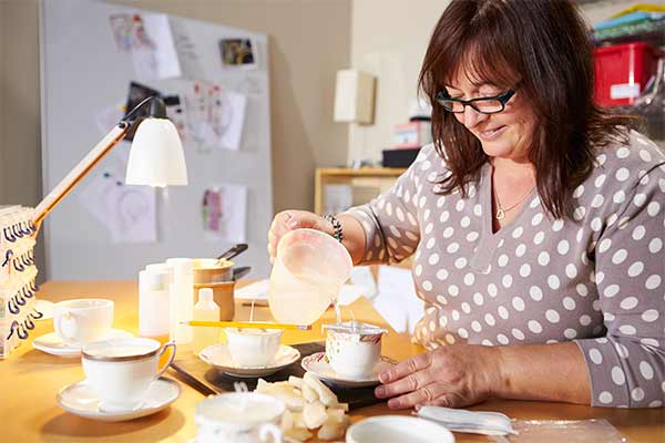 mature woman making candles at home