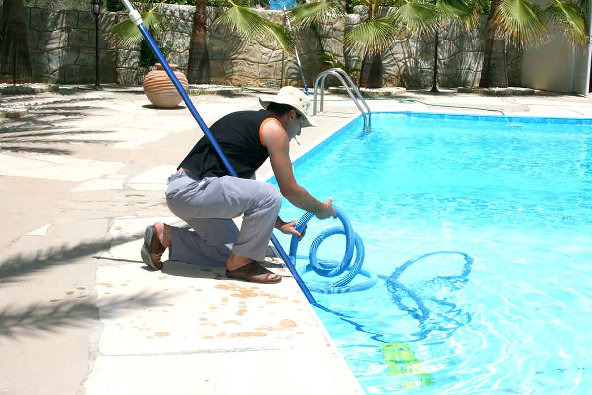 man cleaning a pool