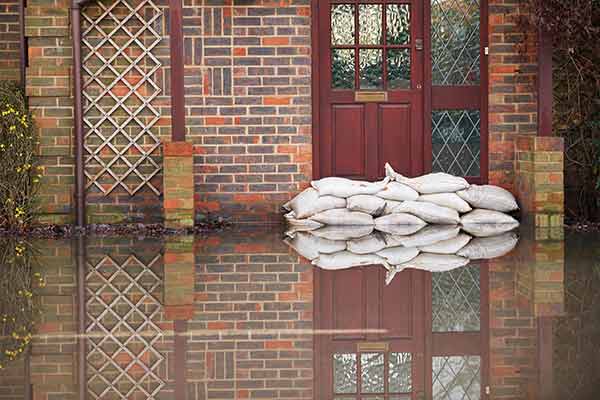 sandbags outside the front door of a flooding house