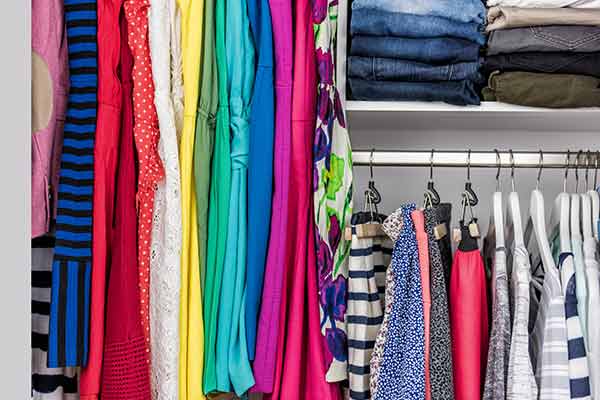 clothes organized in closet by color