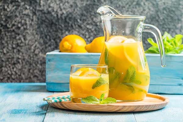 a jug and glass of lemonade