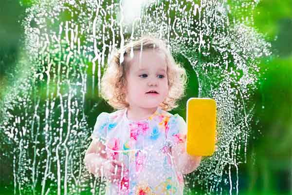 toddler washing a window