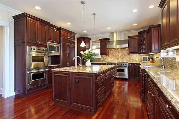 luxury kitchen with cherry wood and marble countertop