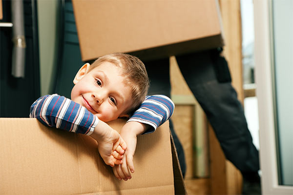 child sitting inside a moving box