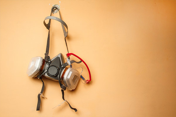 respirator mask hanging on wall