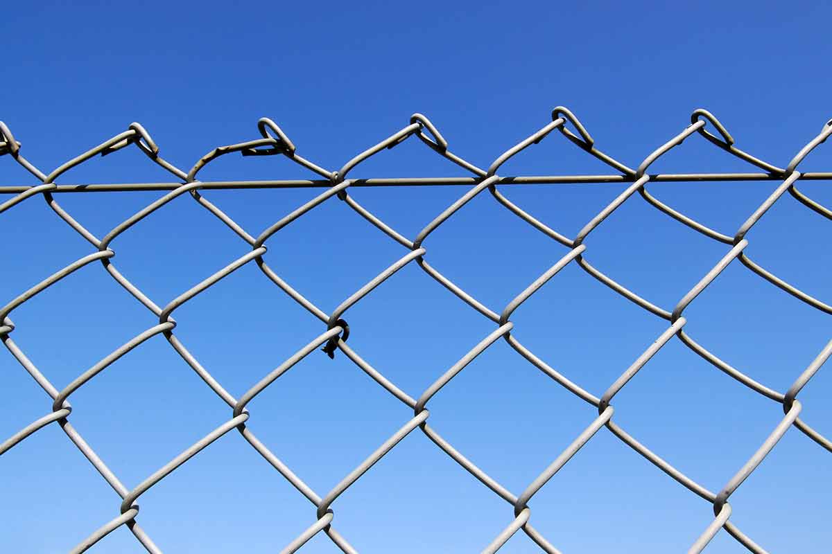 chain link fence isolated against blue sky