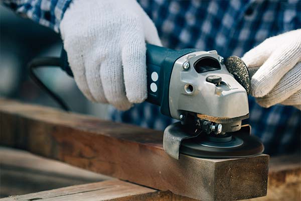 person using power tool on wood