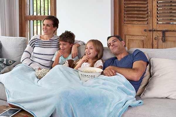 family watching a movie on the couch