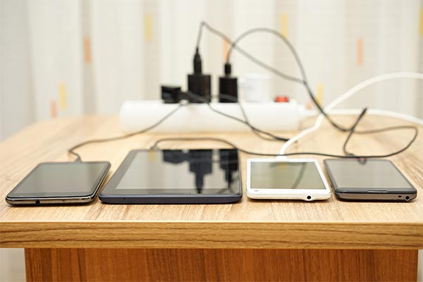 phones and tablets sit on table