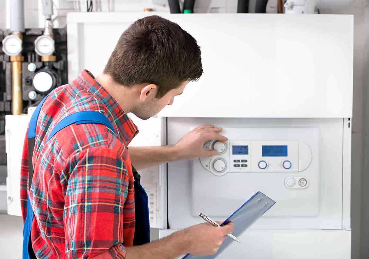 technician adjusting hot water heater boiler