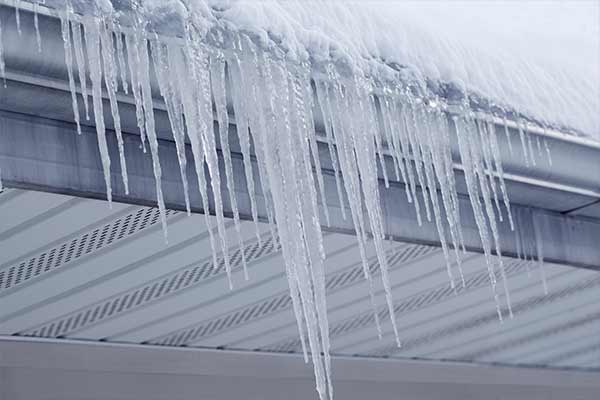 icicles dangle over house gutters