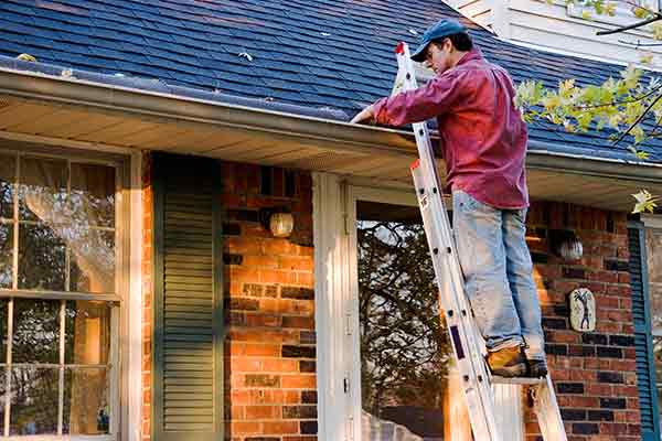 man working on gutters