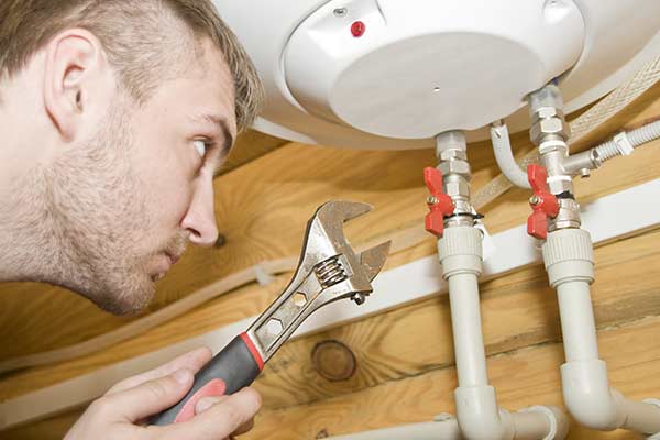 plumber servicing gas boiler