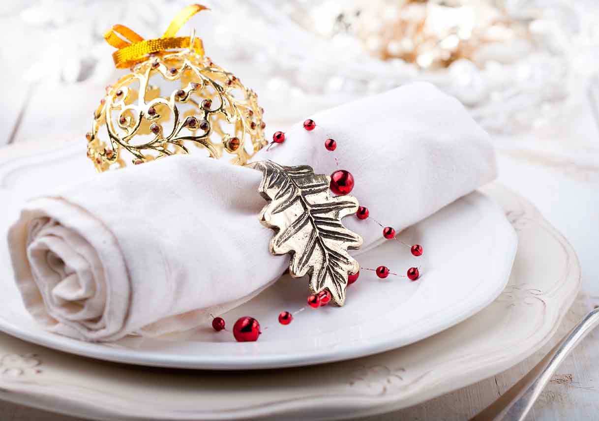 place setting decorated with leaf and ball ornaments