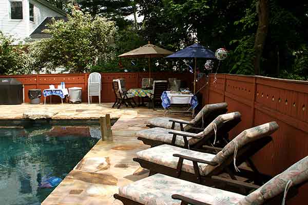 backyard pool with lounge chairs