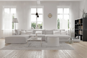 living room with white furniture and light through large windows