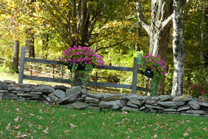 floral baskets on fence posts along path