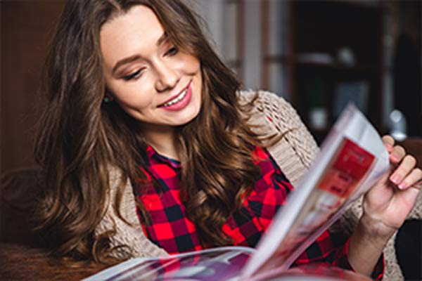 woman reading magazine in home